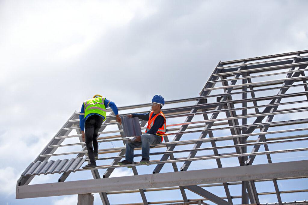 Roofing crew working on a two-story house