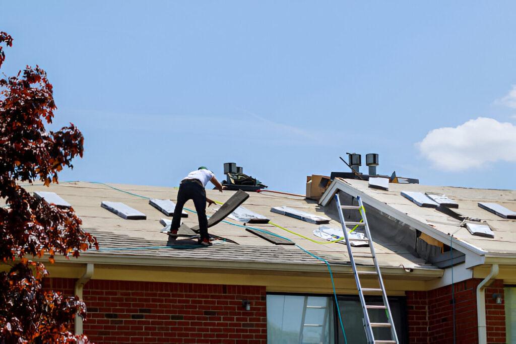 Roofer installing new shingles on Raleigh home